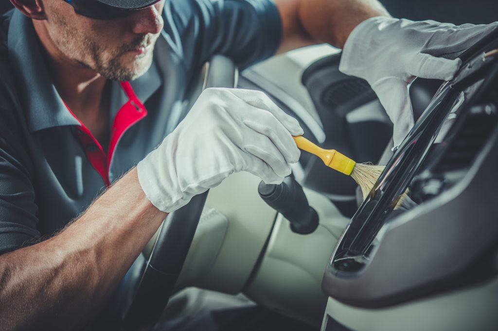 Technician performing interior car detailing in Burlington